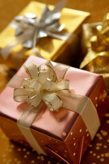 Gold and bronze gift boxes with ribbons.