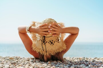 Beach Relaxation woman lies on a pebble beach, legs raised, and arms spread out. The concept of...