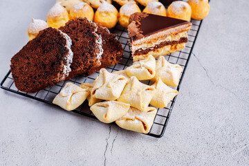 Table with various cookies, pound cake, cake slices, muffins and sweets.