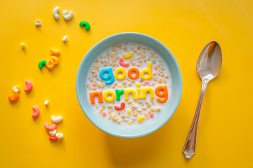 Words made of colorful cereal. Good Morning message in a bowl. Simple and fast breakfast. National cereal day. Minimal creative food concept