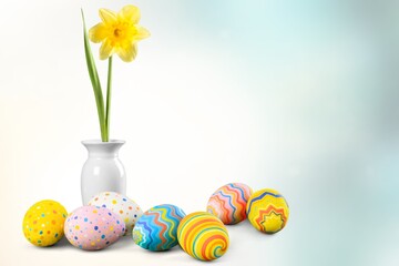 Easter eggs and yellow flower on blur background.