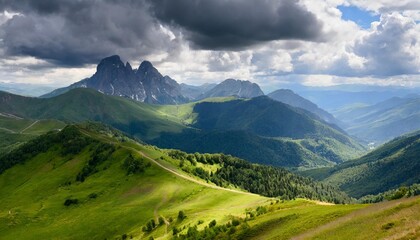 beautiful mountain ranges and peaks with forests and meadows against a stormy sky with clouds