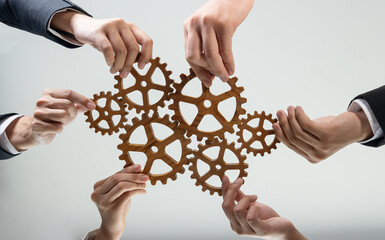 Business team joining cogwheel in circular together symbolize successful group of business...