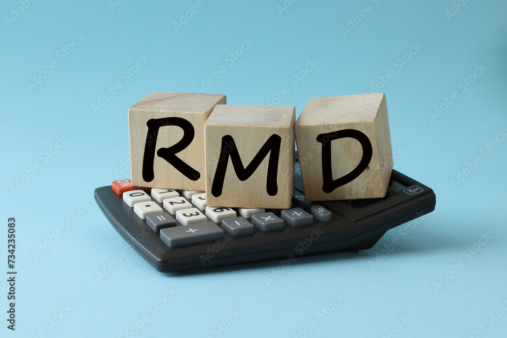 Poster rmd - short for required minimum distribution. blue background with calculator. text on wooden block