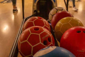 Close up of bowling balls lined up at a bowling alley