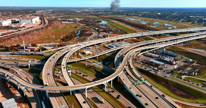 Motorways and freeways intertwining in the downtown of Dallas, Texas, USA. Top view on the uptown of metropolis.