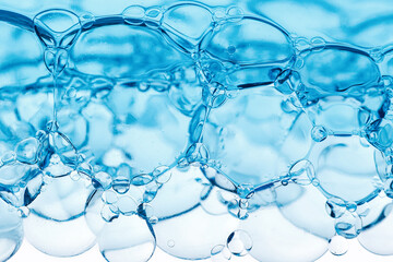 Close-up of bubbles in water, scientific background of cosmetic essence, serum under a microscope. Hydration The concept of developing cosmetics for skin care. Beauty Hydration background