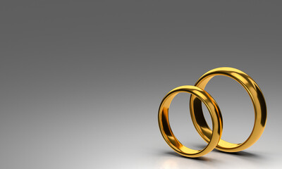 Two wedding gold rings on dark blank background. Love concept
