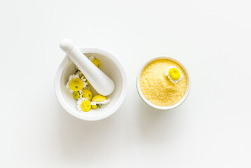 Pharmacy chamomile flowers spa - white mortar with chamomile flowers and sea salt