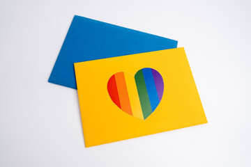 Rainbow heart on a white envelope and color background. LGBT flag. LGBTQIA Pride Month in June....