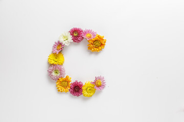 Letter C made of real natural flowers.