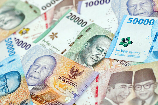 Background image of many indonesian rupiah money bills of new series closed up