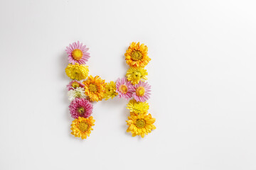 Letter H made of real natural flowers.
