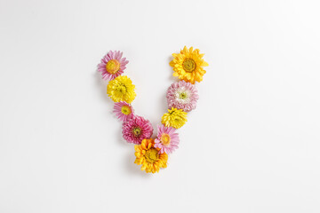 Letter V made of real natural flowers.