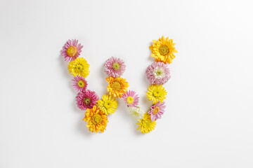 Letter W made of real natural flowers.