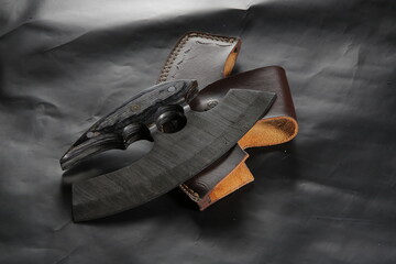 Knife made of Damascus steel with a wooden handle on a white background