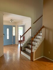 Stairway in an empty, modern home with wood floors and complimenting wall and door colors