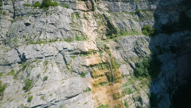 FPV drone flying and diving wonderfull waterfall in Vercors French Alps.