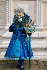 Fototapeta na wymiar Venice, Italy - February 2022 - carnival masks are photographed with tourists in San Marco square