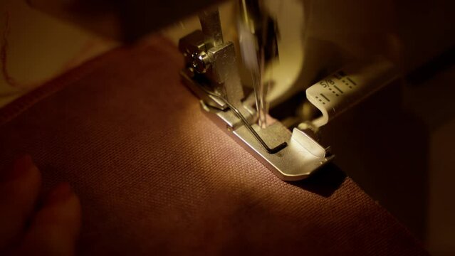 Overlock Sewing Machine Stitching Hem on Fabric. Precision hemming with an overlock sewing machine, showcasing detailed stitching.