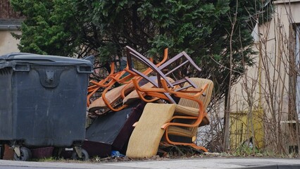 Old Furniture Stacked By Dumpster for Curbside Garbage Collection by City Cleaning Service - obrazy, fototapety, plakaty