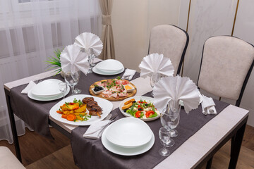 Table set up for four persons in a cafe, cafeteria, restaurant.
