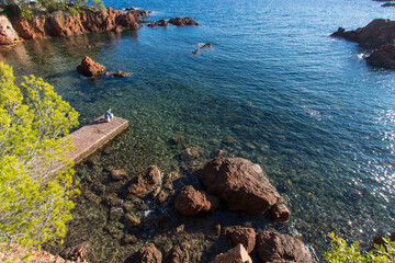 Var, C&ocirc;te d'Azur, bord de mer &agrave; Saint-Rapha&euml;l avec rochers et mer M&eacute;diterran&eacute;e et ponton avec p&ecirc;cheur