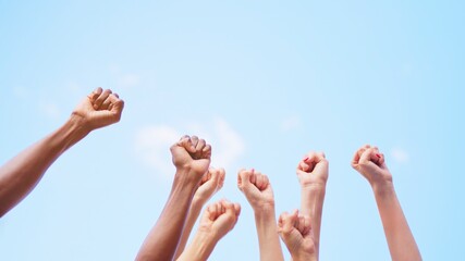Different fists of people waving in the air