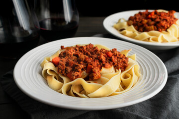 Close-up of a Bowl of Authentic Bolognese Sauce Served Over Pappardelle: Ragu alla bolognese...