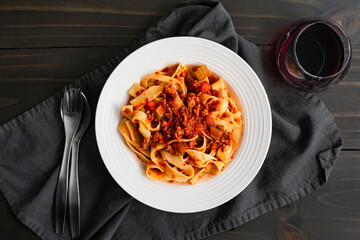 Bowl of Pappardelle Noodles Tossed in Authentic Bolognese Sauce: Close-up of a shallow bowl of...