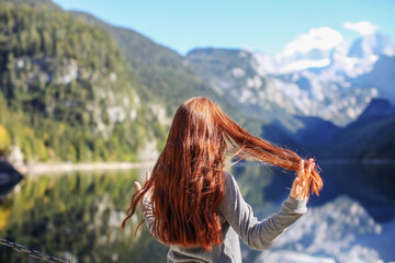 mountain trip. happy girl on the background of a mountain lake Gosausee