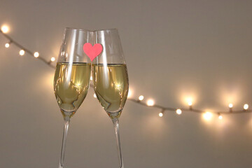 A toast for lovers - two glasses with wine and a red heart, possible as a Valentine's Day card or a...