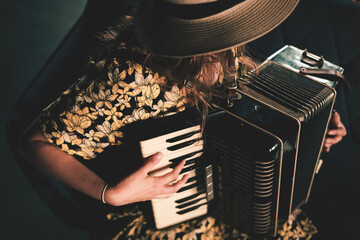 Woman playing the accordion. Close up.
