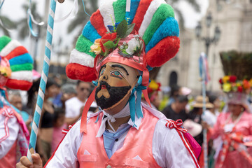 Dancers of the Ancash region with their typical costumes in the parade in the historical center of Lima, Peru.