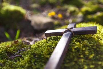 Wooden Cross with flower in fresh spring forest
