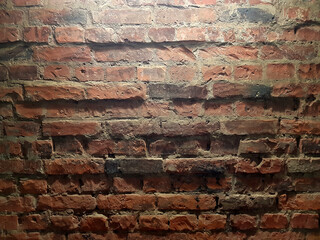 Red brick wall texture background with spotlight.