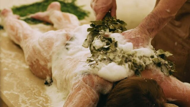 Exclusive care: the hammam has a cozy atmosphere, where the master skillfully conducts a foam procedure with a broom, giving a feeling of relaxation and beauty.