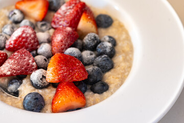 Oatmeal with Strawberries and Blueberries in a Bowl