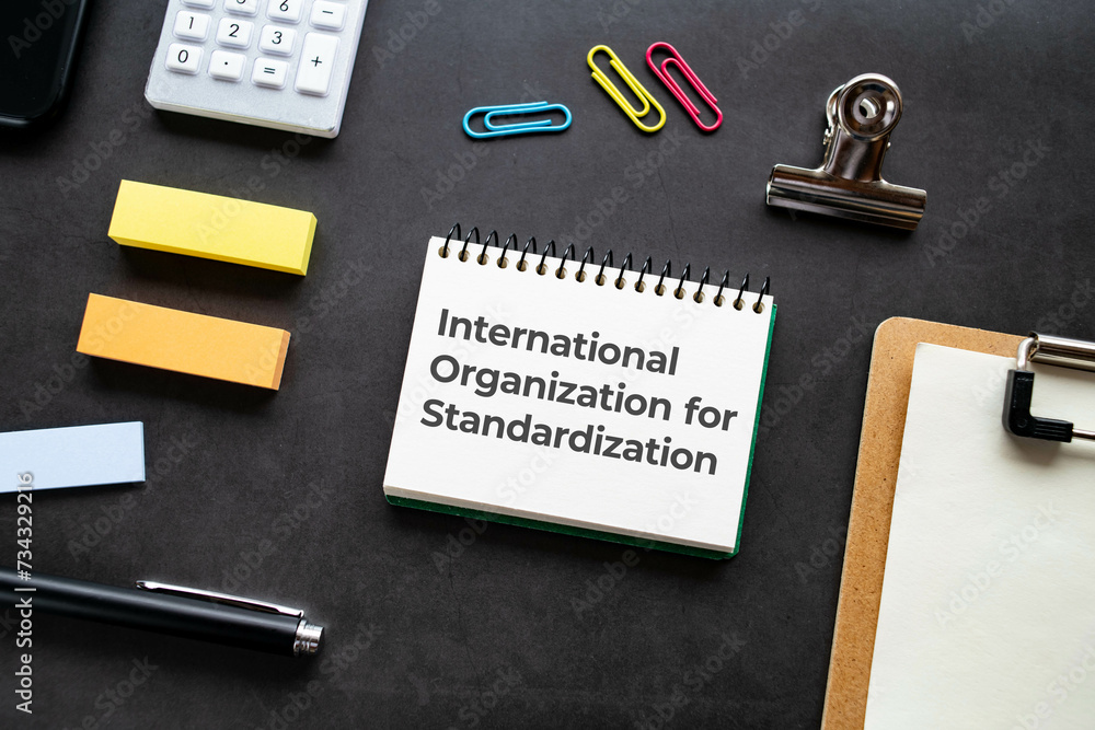 Poster there is notebook with the word international organization for standardization. it is as an eye-catc
