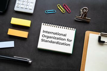 There is notebook with the word International Organization for Standardization. It is as an...