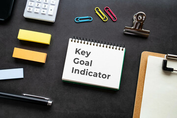 There is notebook with the word Key Goal Indicator. It is as an eye-catching image.