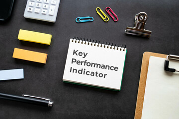 There is notebook with the word Key Performance Indicator. It is as an eye-catching image.