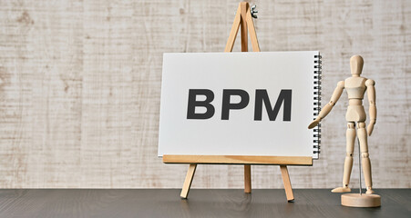 There is notebook with the word BPM. It is an abbreviation for Business Process Management as eye-catching image. - obrazy, fototapety, plakaty