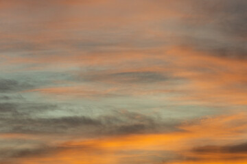 Golden, orange and blue clouds at sunset