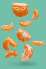Peeled flying tangerines on turquoise background