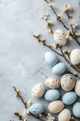 Fototapeta premium Easter eggs and spring flowers on a marble background. Top view with copy space.Spring Awakening: Easter Eggs and Blossoms on a Textured Surface