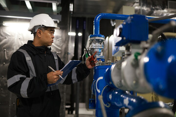 A senior engineer is testing the energy flow to inspect the quality of equipment on the piping...
