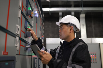 Mechanical Engineer using a digital tablet to Examine the Pipeline  system of cooling installation