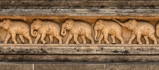 Ancient carvings of elephants around the walls of the Kelaniya Temple, Sri Lanka