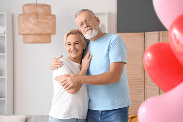 Mature couple hugging at home on Valentine's Day